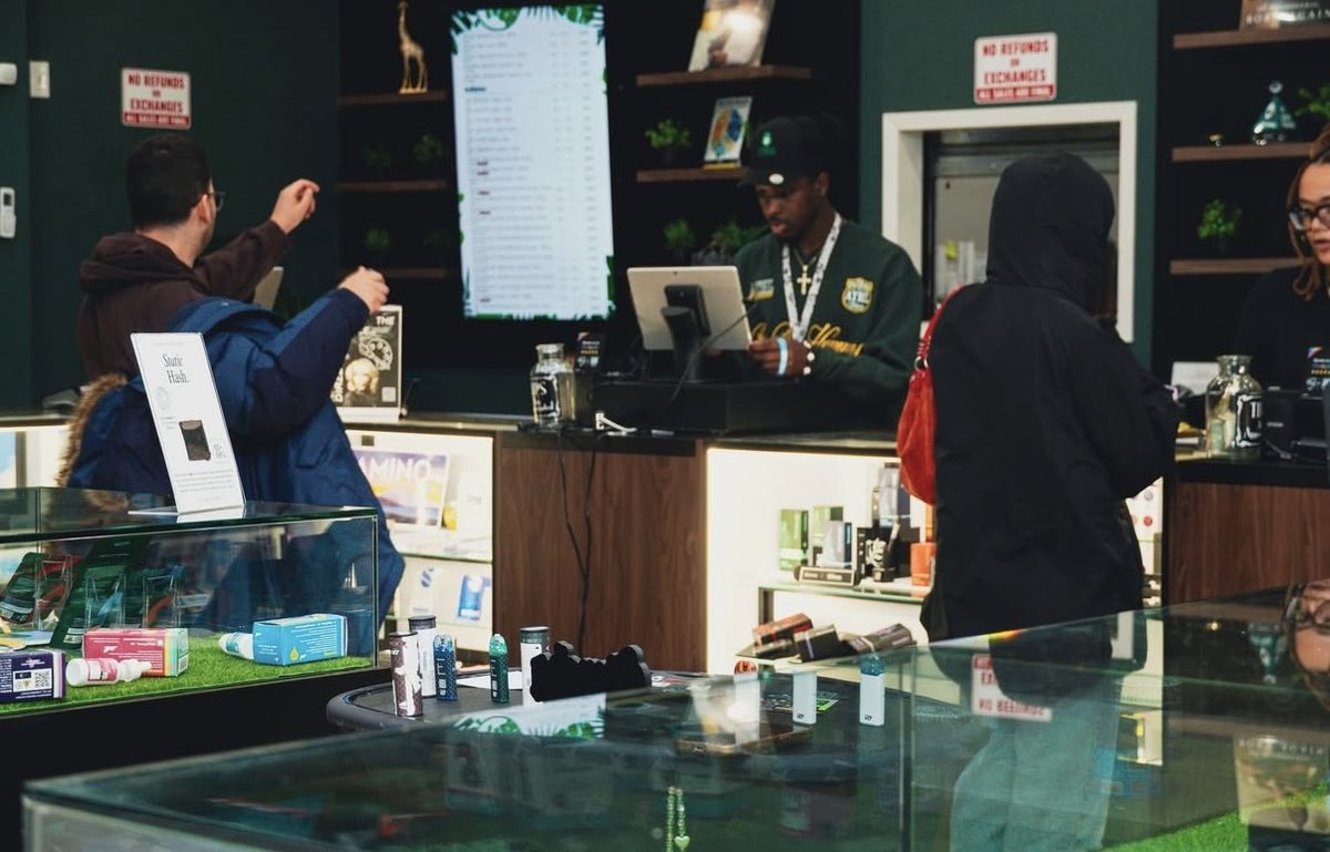 Customers and staff at the service counter inside Jungle Kingdom Flower dispensary in Bed-Stuy Brooklyn